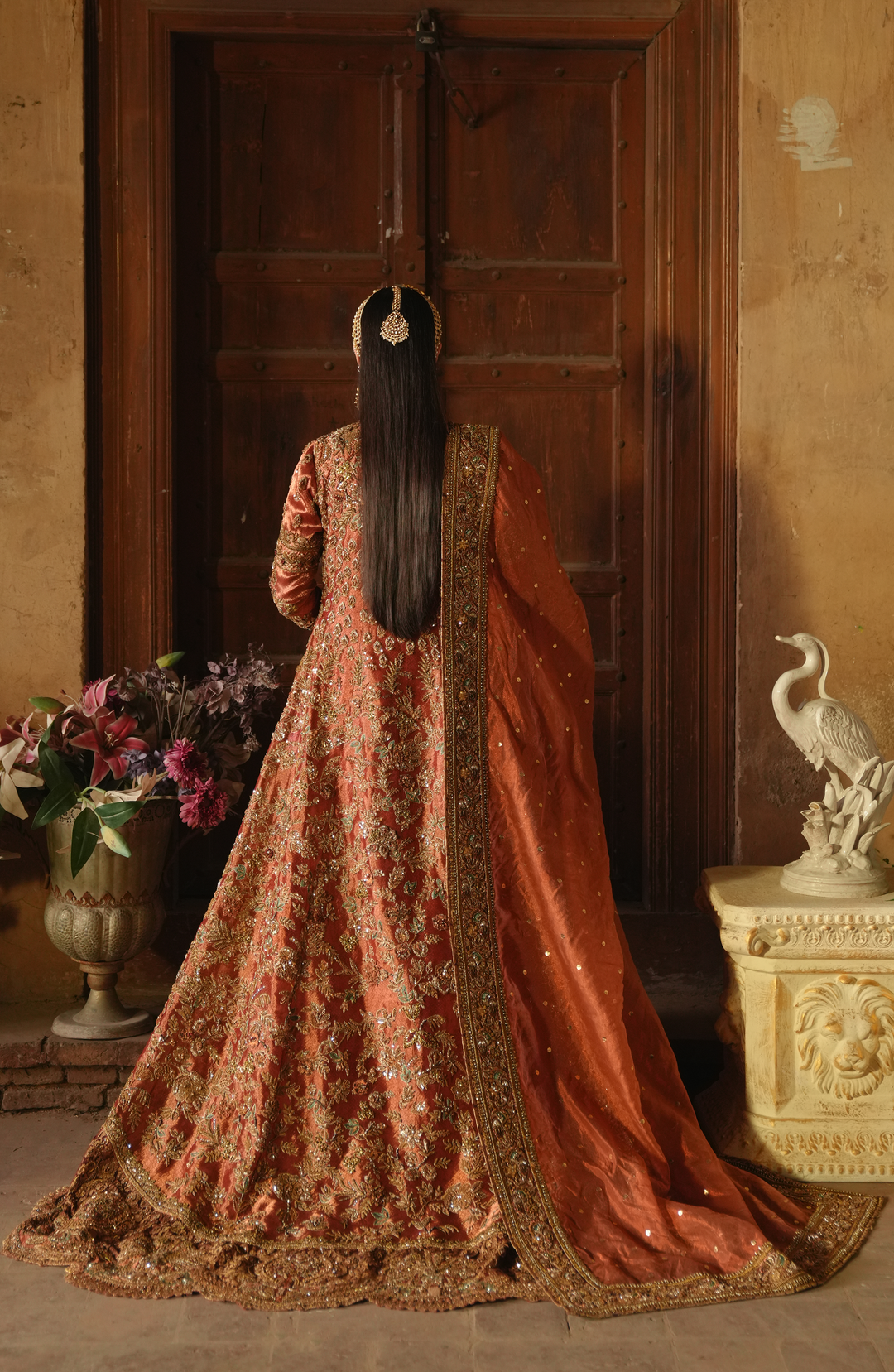 Copper-Rust Pakistani Bridal Dress with Dramatic Flair