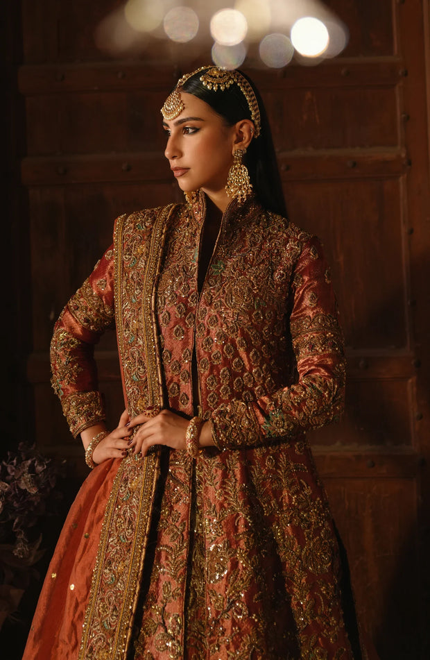 Copper-Rust Pakistani Bridal Dress with Dramatic Flair