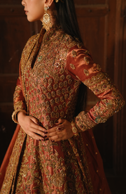 Copper-Rust Pakistani Bridal Dress with Dramatic Flair