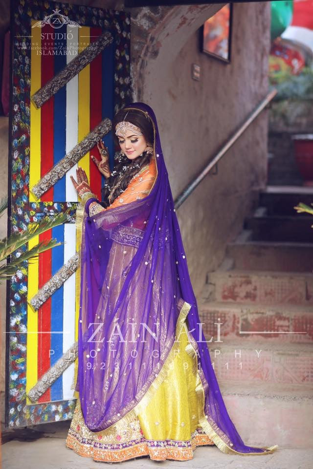 Stylish Mehndi Attire In Orange Green And Purple Color.Work Embellished With Dabka Zari And Gota Work.