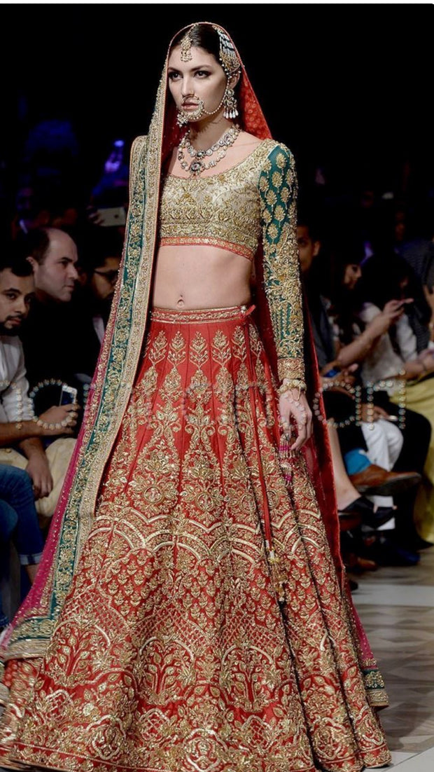 Nomi Ansari Bridal Lahnga Choli In Hot Red Color In In Indian Style.Work Embalished With Pure Dull Gold Dabka,Zari,Nagh Sequance And Green Appliqué Work.