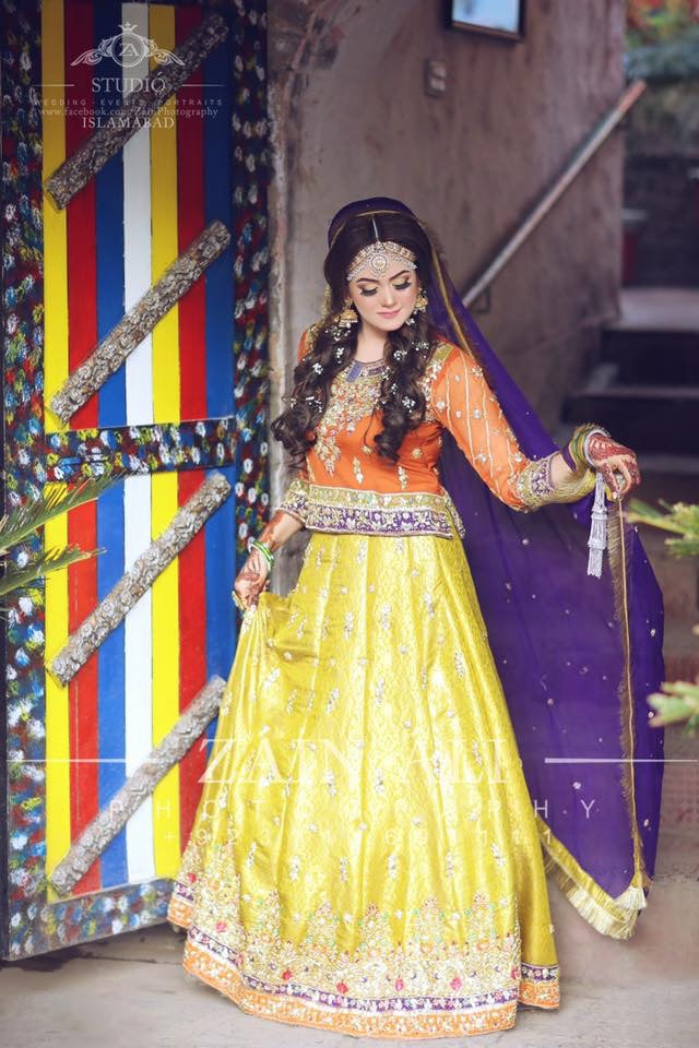 Stylish Mehndi Attire In Orange Green And Purple Color.Work Embellished With Dabka Zari And Gota Work.