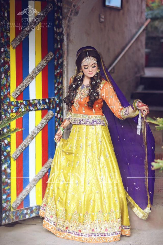 Stylish Mehndi Attire In Orange Green And Purple Color.Work Embellished With Dabka Zari And Gota Work.