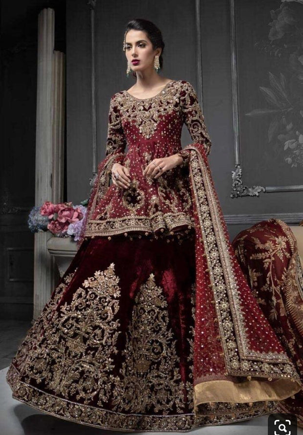 Indian Bridal Ghagra Choli In Beautiful Maroon Red Color.Work Embellished With Pure Dabka Nagh Pearls Stone And Valvet Appliq Work In Dull Gold Color.