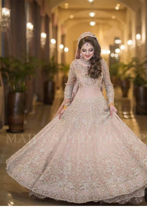 Walima Dulhan Maxi in Beutifull Pastel Pink Color.Work Embellished With Pure Dabka,Dhaga,Zari,Naqshe,And Pearls Work.This Dress Can Changeable In Any Desiring Color.