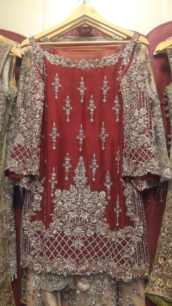 Pakistani Dulhan Suit In Beautiful Maroon Color.Work Embalished With Dull Golden Dabka ,Nagh,Zari,Stone And Pearls.