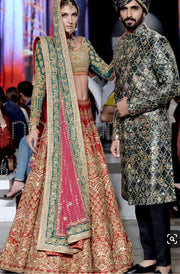 Nomi Ansari Bridal Lahnga Choli In Hot Red Color In In Indian Style.Work Embalished With Pure Dull Gold Dabka,Zari,Nagh Sequance And Green Appliqué Work.