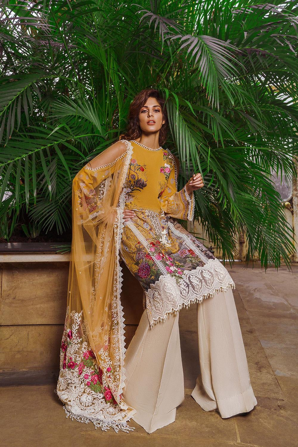 Pakistani Lawn Suit By Sonia Nazir In Beautiful Yellow Gold Color.Work Embellished With Three D Prints Hevey Multi Threads Embroidery And Daman Cutwork Patches.