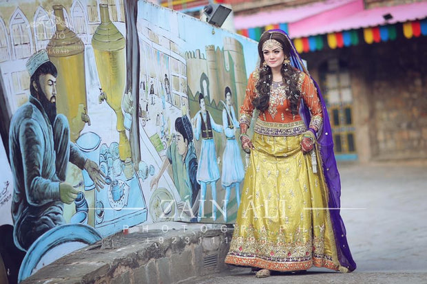 Stylish Mehndi Attire In Orange Green And Purple Color.Work Embellished With Dabka Zari And Gota Work.