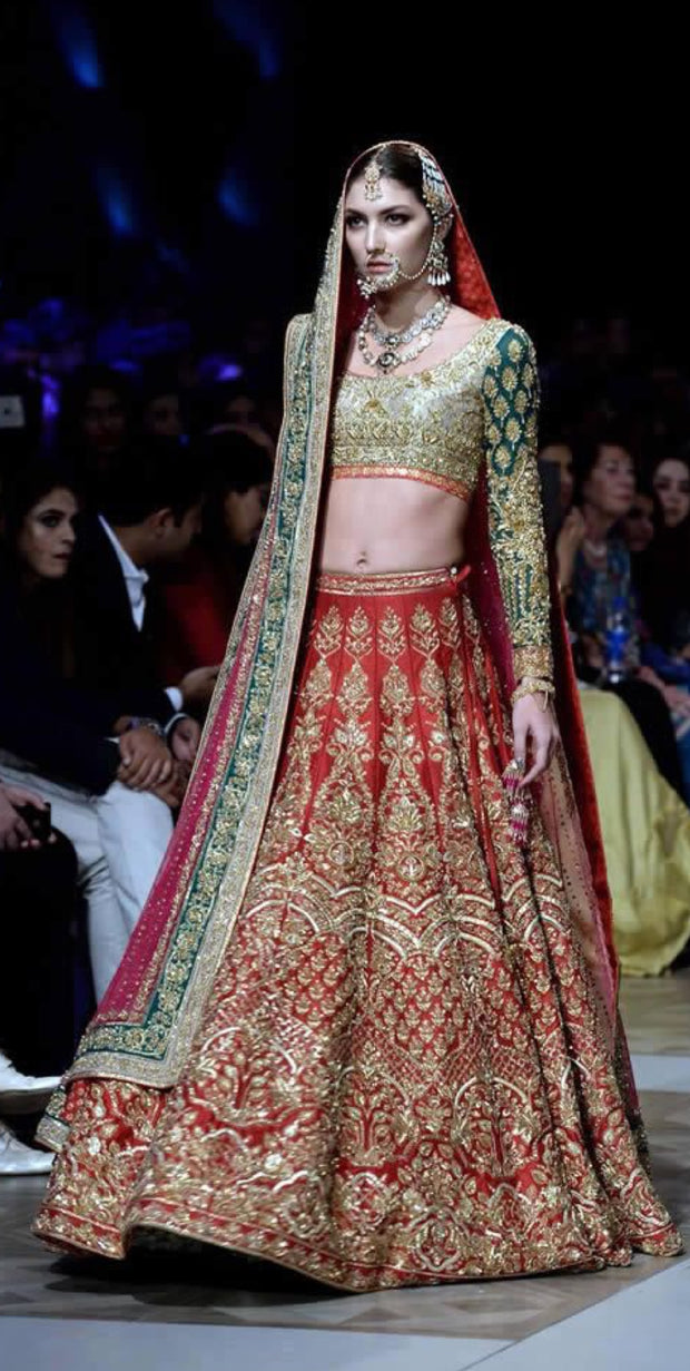 Nomi Ansari Bridal Lahnga Choli In Hot Red Color In In Indian Style.Work Embalished With Pure Dull Gold Dabka,Zari,Nagh Sequance And Green Appliqué Work.