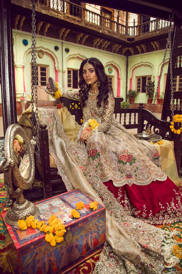 Beautiful bridal lahnga in red and gold with heavy dabka nagh pearls threds and crystals work 