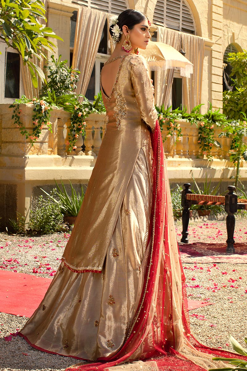 golden dress with red dupatta Our beautiful bride, Amna, looks absolutely stunning in our vibrant red  dress paired with a light golden dupatta