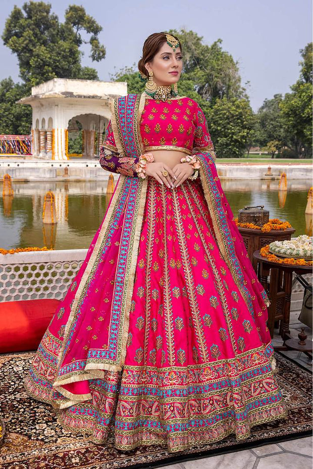 RANI PINK LEHENGA SET WITH ALL OVER PATTERNED EMBROIDERY PAIRED WITH A  MATCHING DUPATTA, GOLD AND SILVER HIGHLIGHTS AND TASSELS. - Seasons India