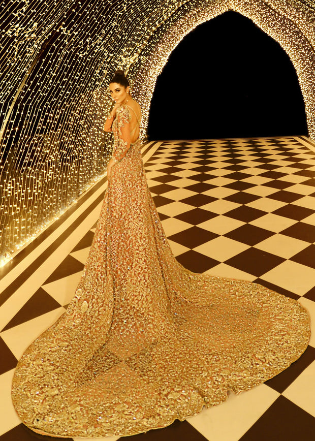 Embroidered gown in peach color with golden embroidered work Nameera by Farooq Embroidered gown in peach color with golden embroidered work Nameera by Farooq